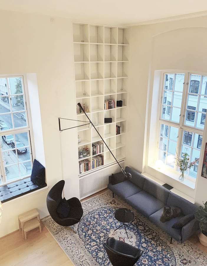 Indbygget væg-til-væg reol med radiatorskjuler. Herskabelig lejlighed med skræddersyet reol fra Jesper Holm Design København.